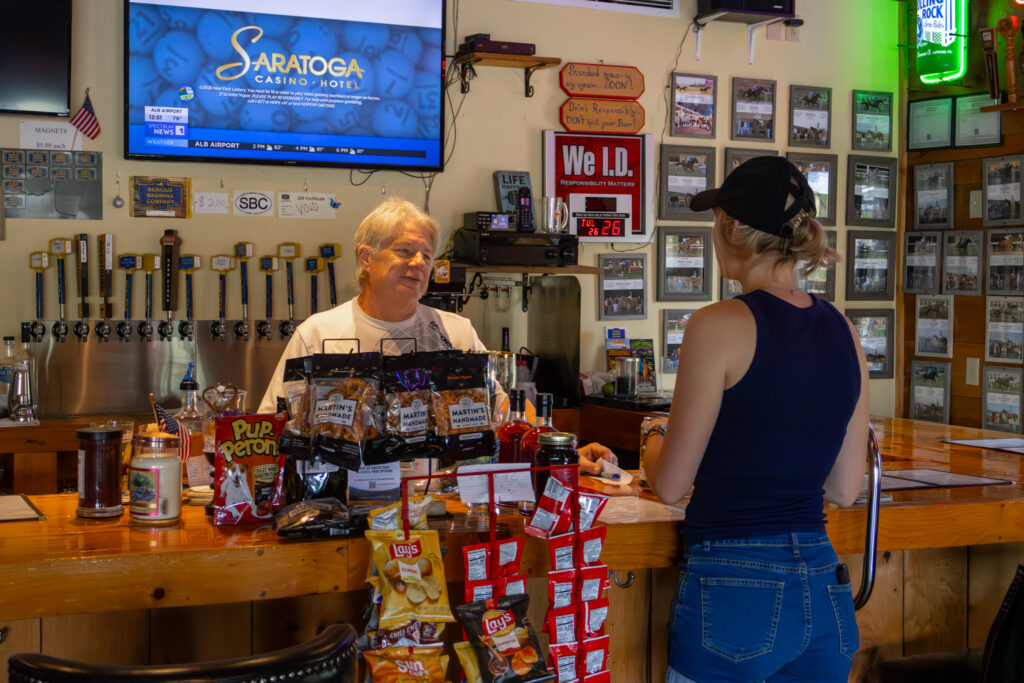 Bill, the owner, talking with a customer at the bar.